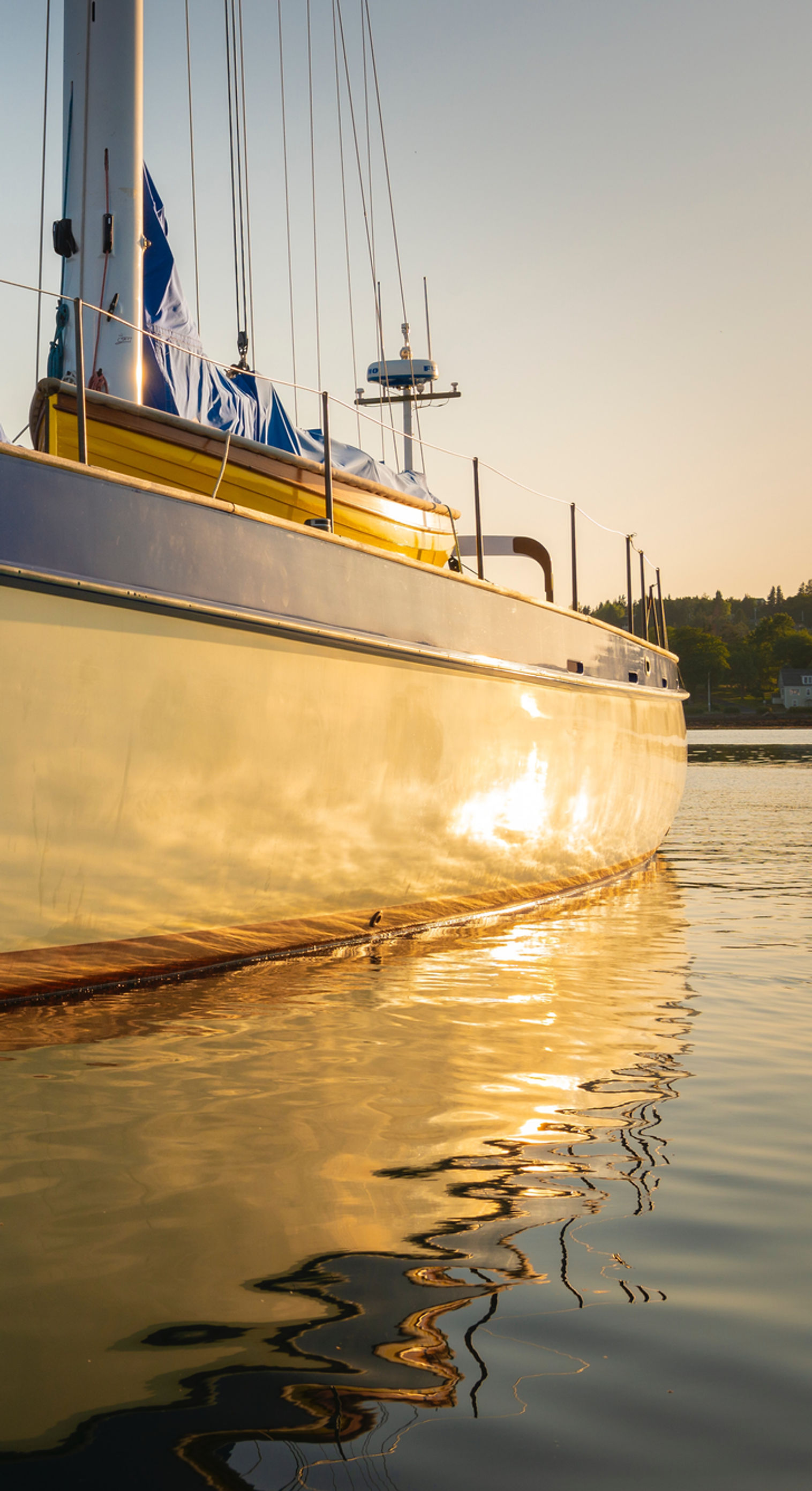 Sailboat hull gleaming in golden sunset light